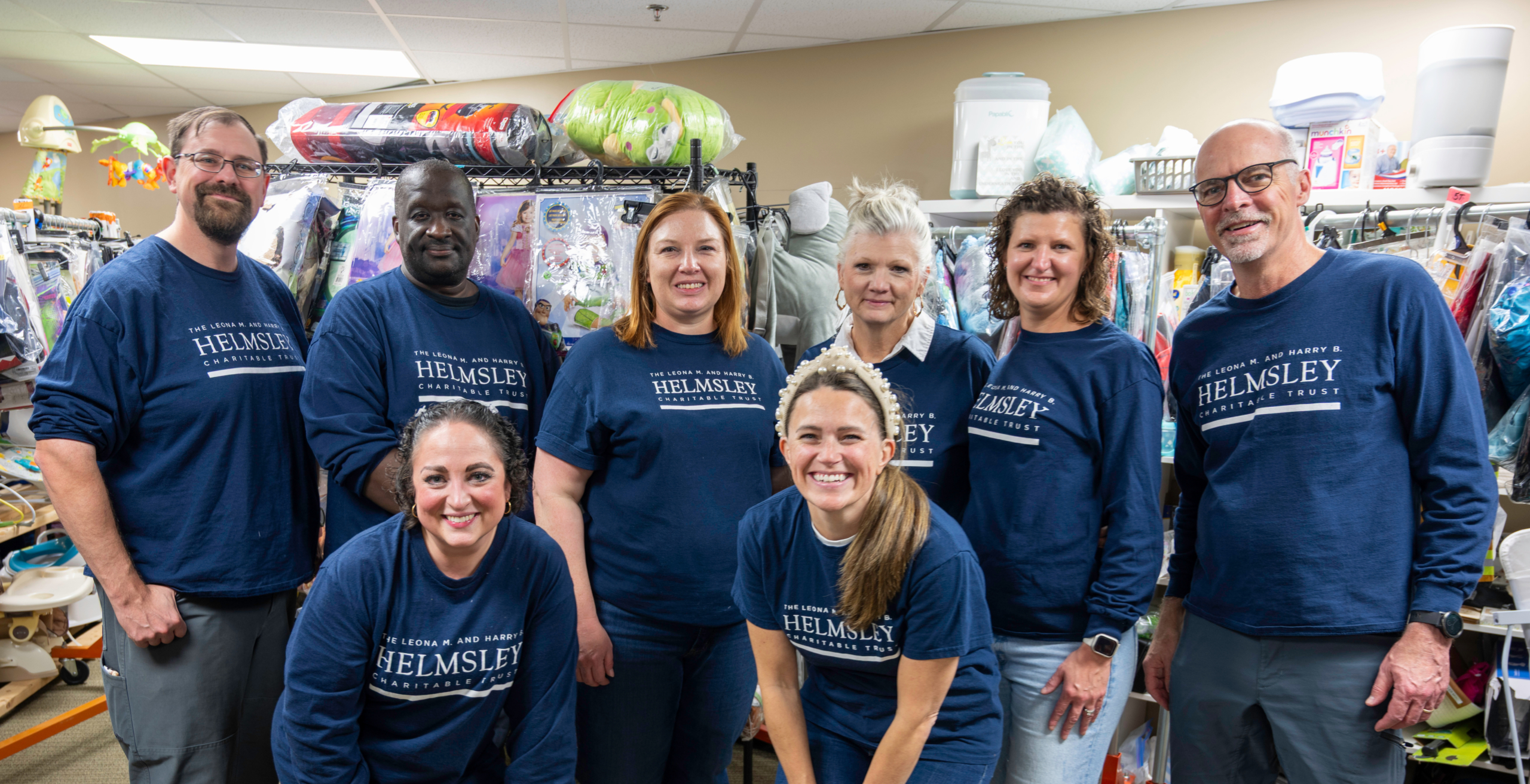 Helmsley staff posing for a photo wearing shirts with the Helmsley logo.